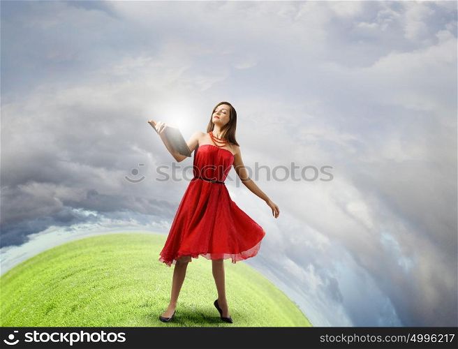 Woman with book. Young woman in red dress with book in hand