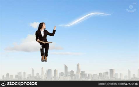 Woman with book. Young woman sitting on cloud with book in hands