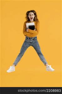 woman with books jumping