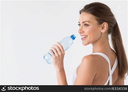 Woman with bottle of water. Young beautiful fit woman drinking water after exercise