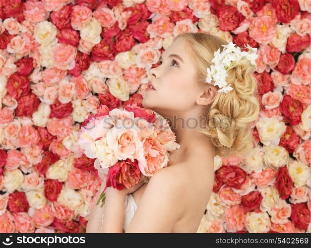 woman with bouquet of flowers and background full of roses