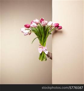 Woman with bouquet of flowers in her hands. Flowers. Spring. Tulips. March 8. Fashion photo