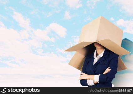 Woman with box. Confident businesswoman wearing carton box on head