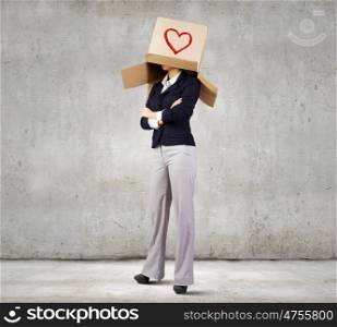 Woman with box. Confident businesswoman wearing carton box on head