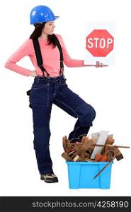 Woman with box of debris and stop sign