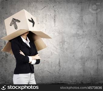 Woman with box on head. Businesswoman wearing carton box with drawings on head