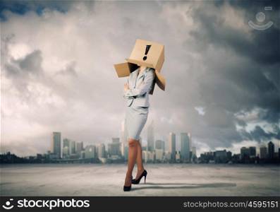 Woman with box on head. Businesswoman wearing on head carton box with sign