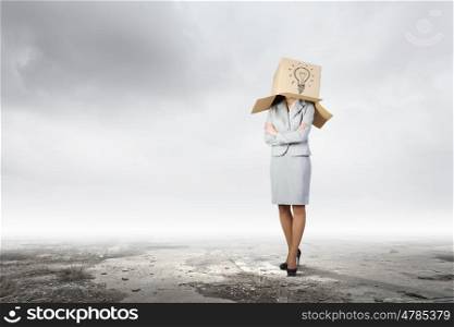 Woman with box on head. Businesswoman wearing on head carton box with sign