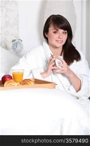Woman with breakfast in bed