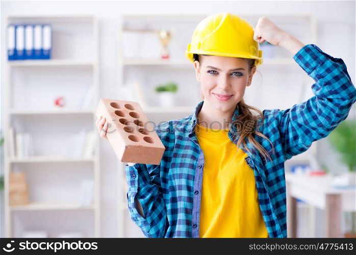 Woman with brick in construction concept. The woman with brick in construction concept