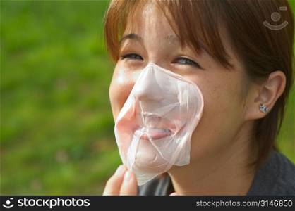 Woman With Bubble Gum On Her Face