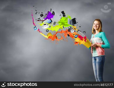 Woman with bucket. Young woman in casual holding yellow bucket with icons