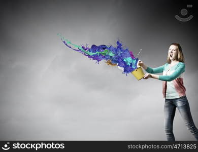 Woman with bucket. Young woman in casual holding yellow bucket with splashes