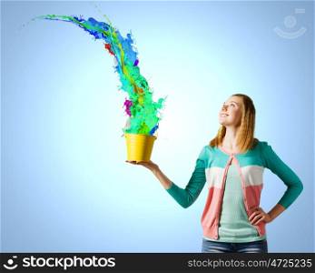 Woman with bucket. Young woman in casual holding yellow bucket with splashes