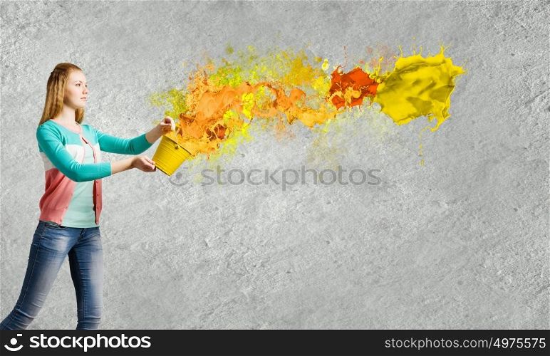 Woman with bucket. Young woman in casual holding yellow bucket with splashes