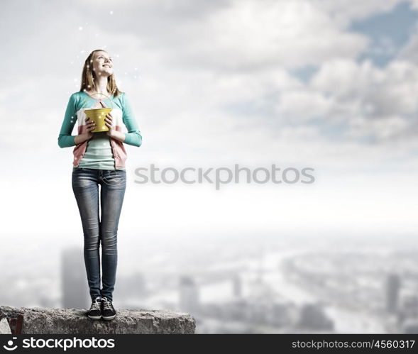 Woman with bucket. Young woman in casual with yellow bucket in hands