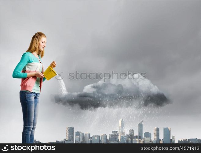 Woman with bucket. Young woman pouring water from bucket on cloud