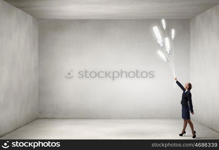 Woman with bulb balloon. Businesswoman holding in hand bunch of light bulb balloons