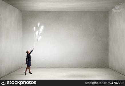 Woman with bulb balloon. Businesswoman holding in hand bunch of light bulb balloons