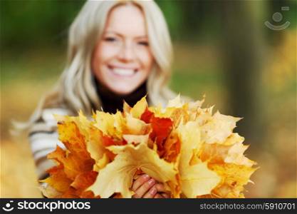 Woman with bunch of autumn orange maple leaves . Woman with bunch of autumn leaves