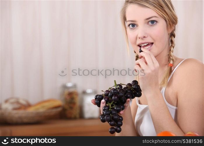 Woman with bunch of grapes
