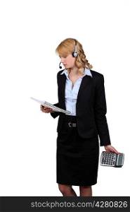 Woman with calculator and notebook in hand