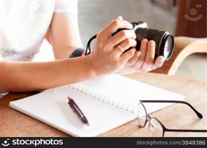 Woman with camera in the hands, stock photo
