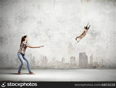 Woman with cat. Young woman in casual and cat on lead
