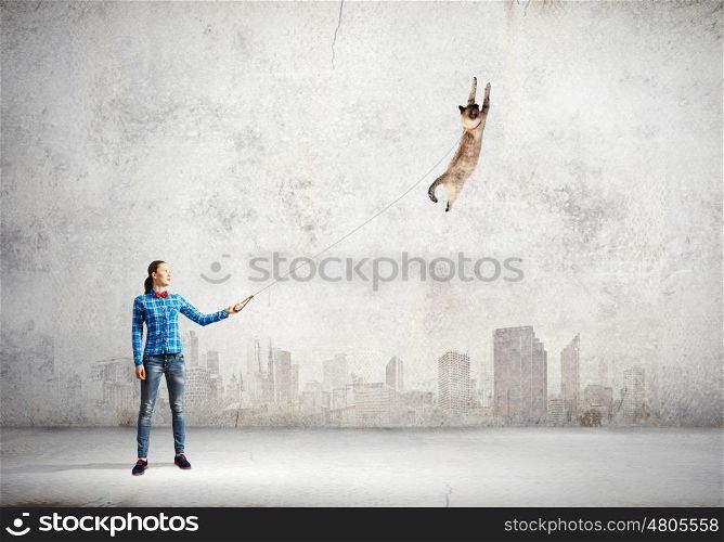 Woman with cat. Young woman in casual and cat on leash