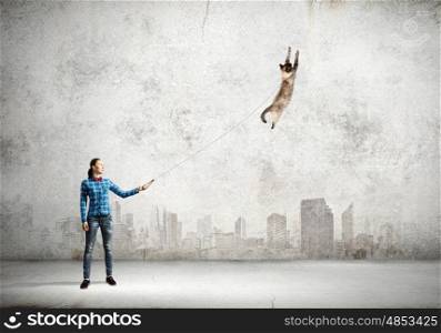 Woman with cat. Young woman in casual and cat on leash