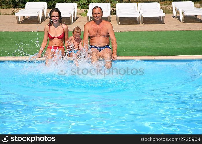 Woman with child and man seat the pool board