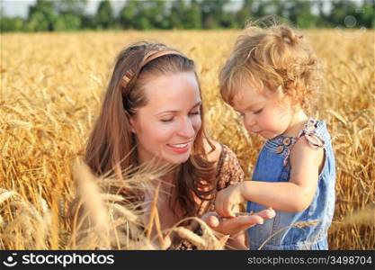 Woman with child in field of wheat