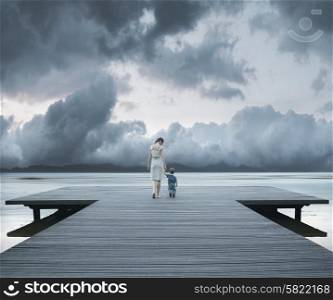 Woman with child on the jetty