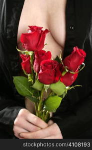 Woman with cleverage on show holding red roses