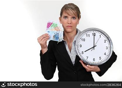 Woman with clock and notes in hand