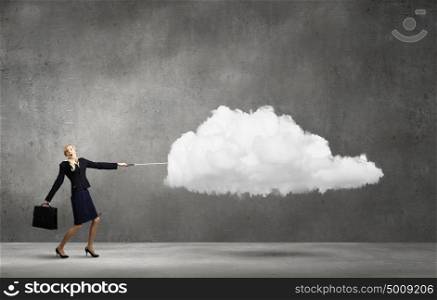 Woman with cloud. Young businesswoman pulling white cloud with rope