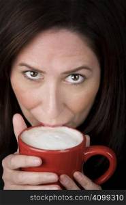 Woman with coffee specialty drink in a red cup