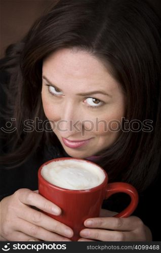 Woman with coffee specialty drink in a red cup