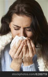 Woman With Cold Holding Tissue And Sneezing