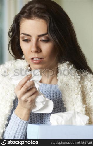 Woman With Cold Holding Tissue And Sneezing