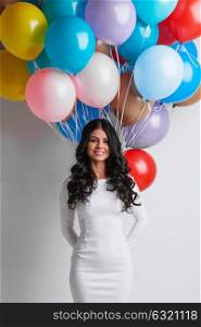 Woman with colorful balloons. Cheerful woman holding many colorful balloons, celebration and happiness concept
