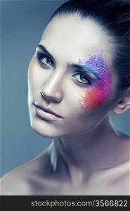 woman with coloured powder above eye