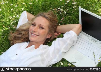 woman with computer in a field