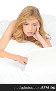 Woman with computer in bed