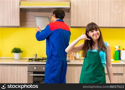 Woman with contractor at kitchen discussing repair
