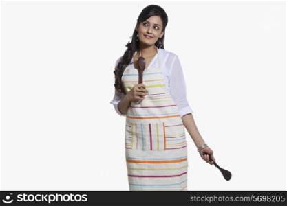 Woman with cooking utensils