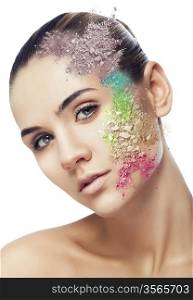 woman with cracked coloured powder on face on white background