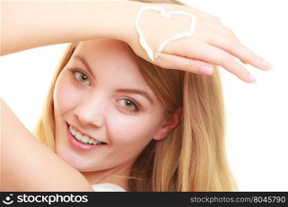 woman with cream on palm.. Skincare. Closeup of female hand with cream in heart form. Young woman girl taking care of her dry hands palms applying moisturizing lotion. Beauty treatment.