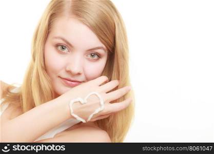 woman with cream on palm.. Skincare. Closeup of female hand with cream in heart form. Young woman girl taking care of her dry hands palms applying moisturizing lotion. Beauty treatment.