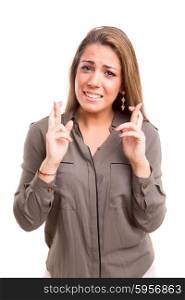 Woman with crossed fingers, isolated over a white background